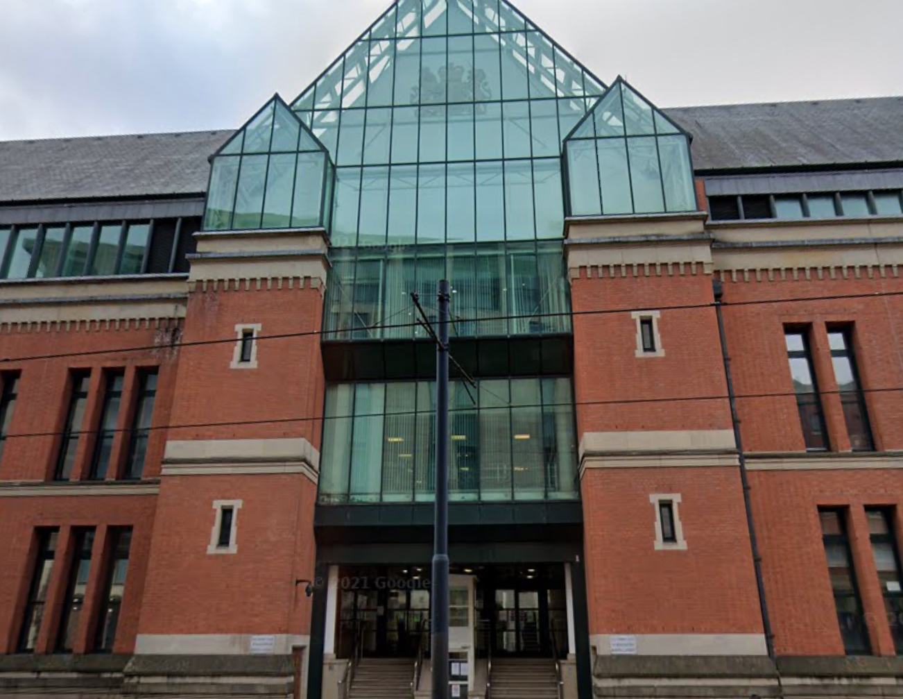 The image shows an exterior shot of Manchester Minshull Street Crown Court